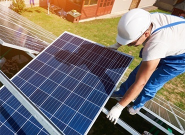 Professional solar installer working on a residential solar panel installation